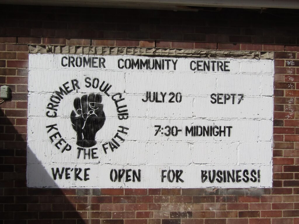 A northern soul club sign with the clenched fist and the words Keep the Faith